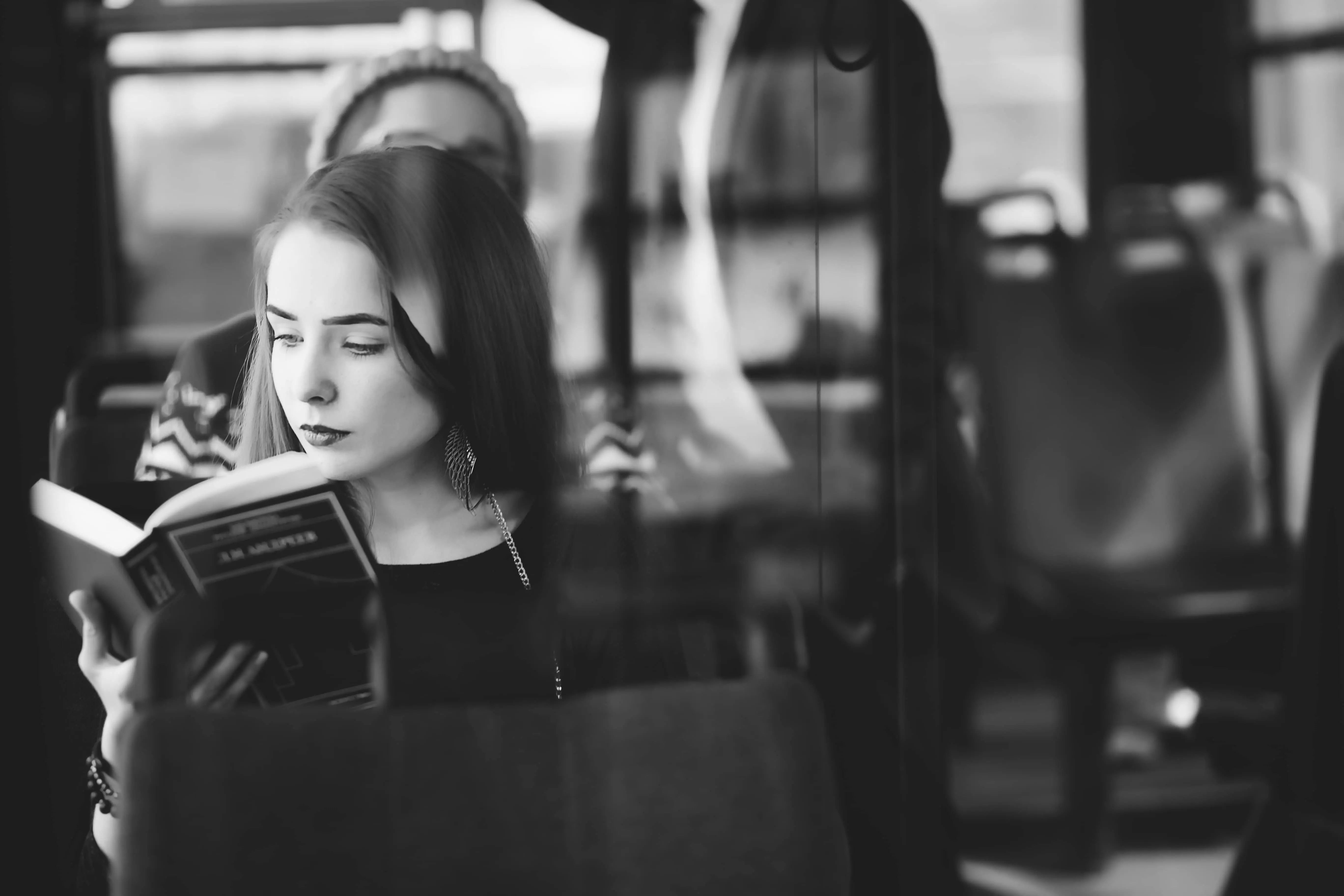 Train Literature: A sepia tone image of a woman reading a book.