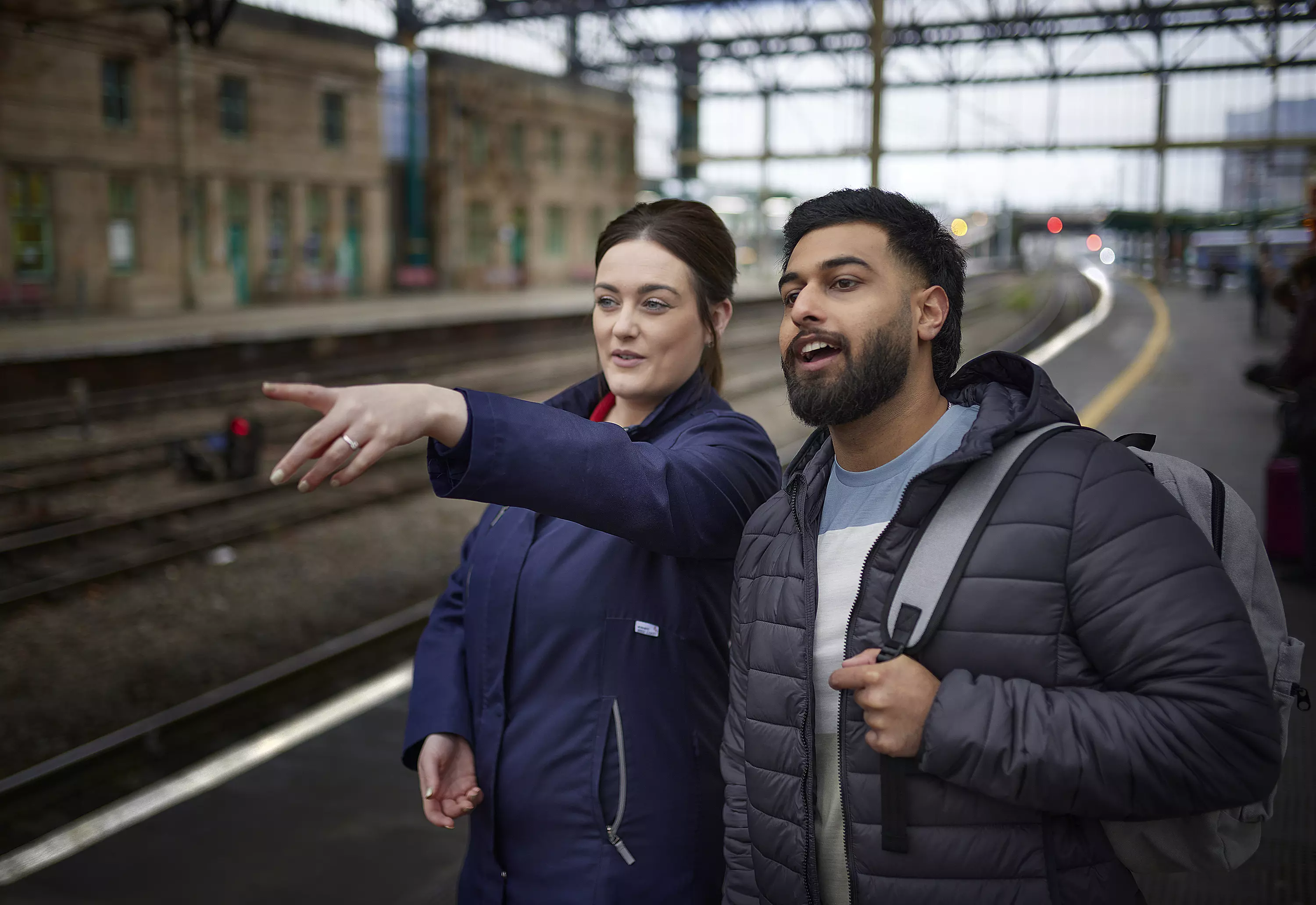 An image of an Avanti member helping a customer in the station