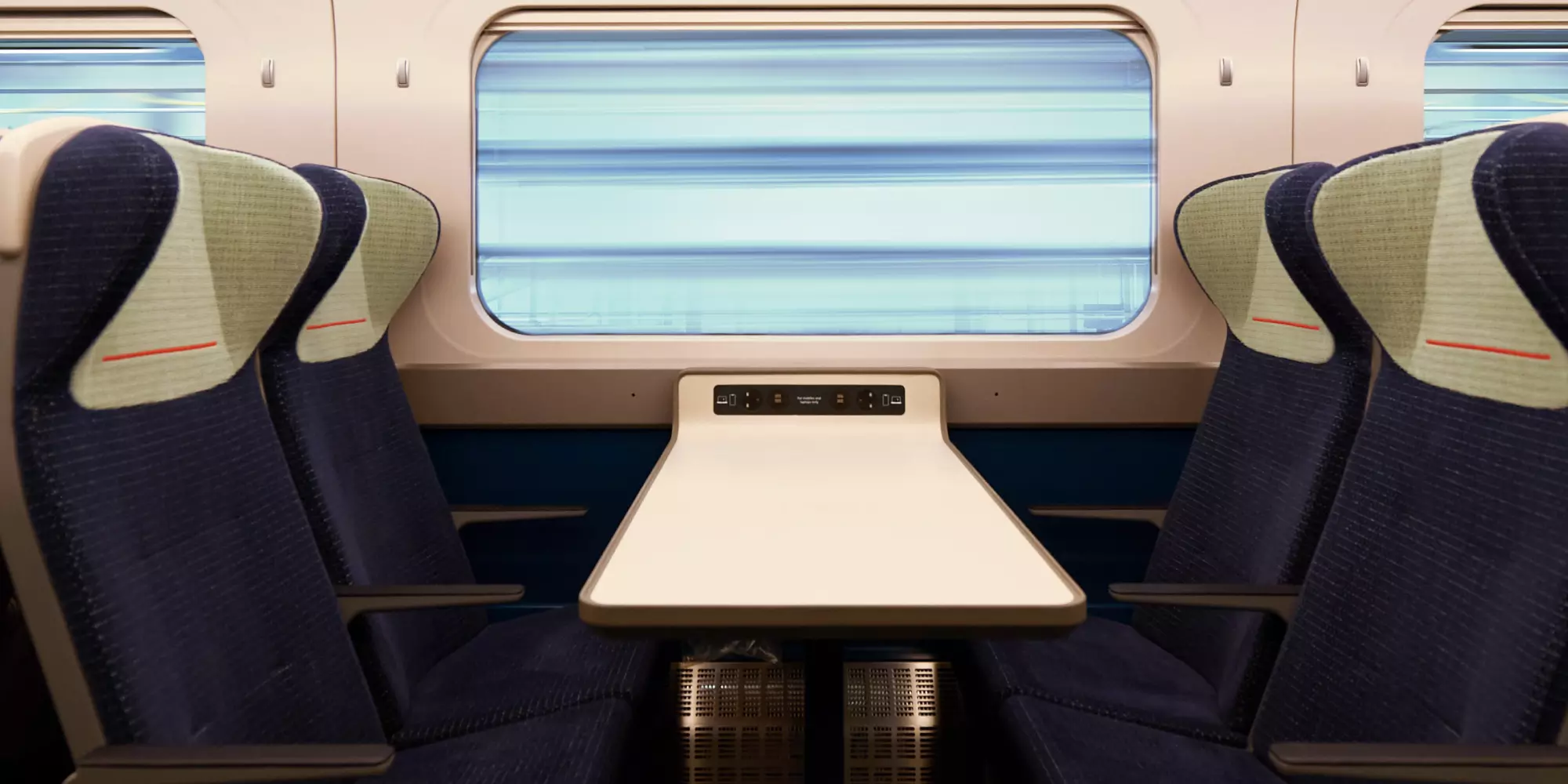 Looking inside the train there’s a table with two seats either side, there’s a fair amount of space to stretch your legs.