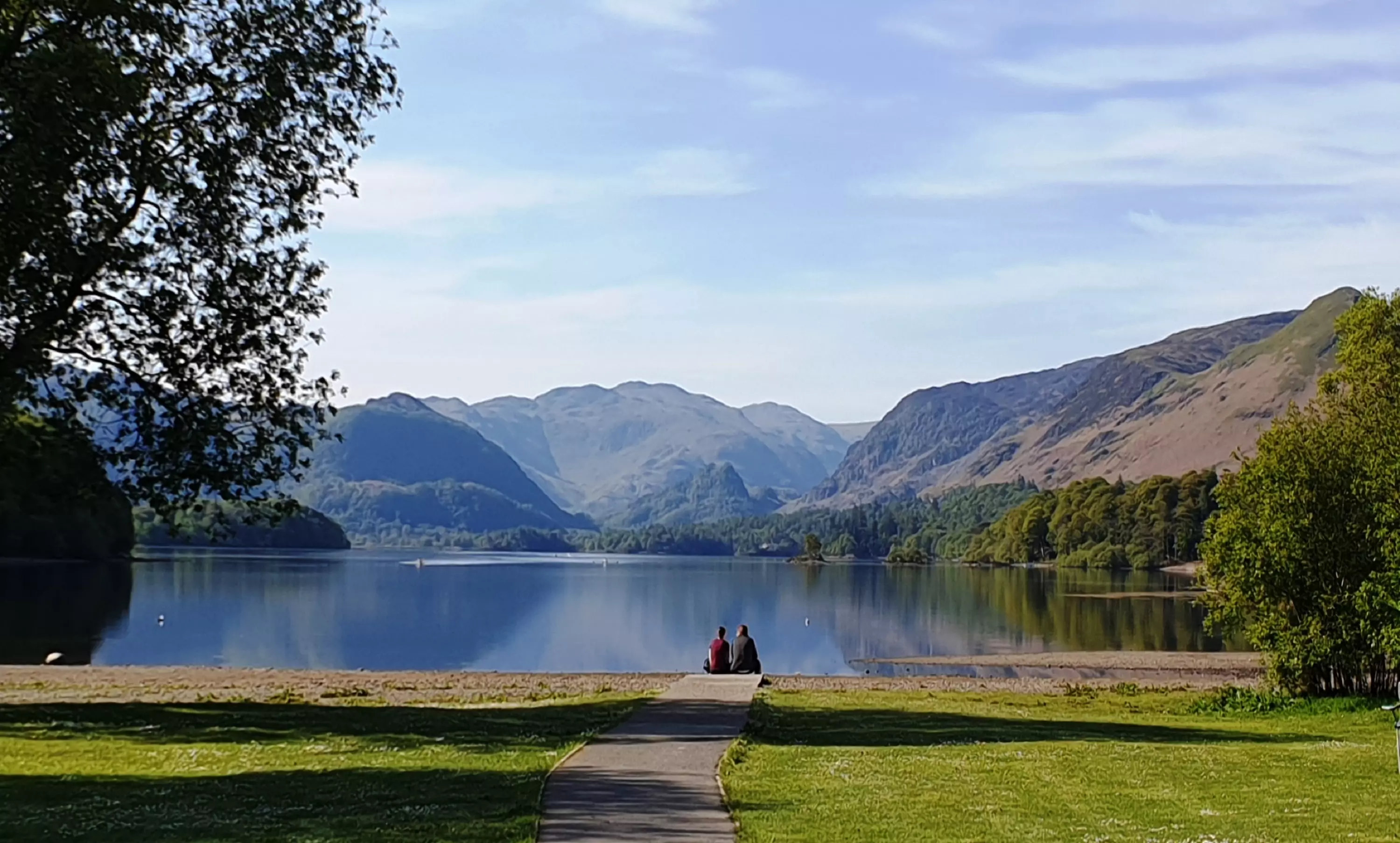 Couple sitting by the lake with a wide angle view of the scenery