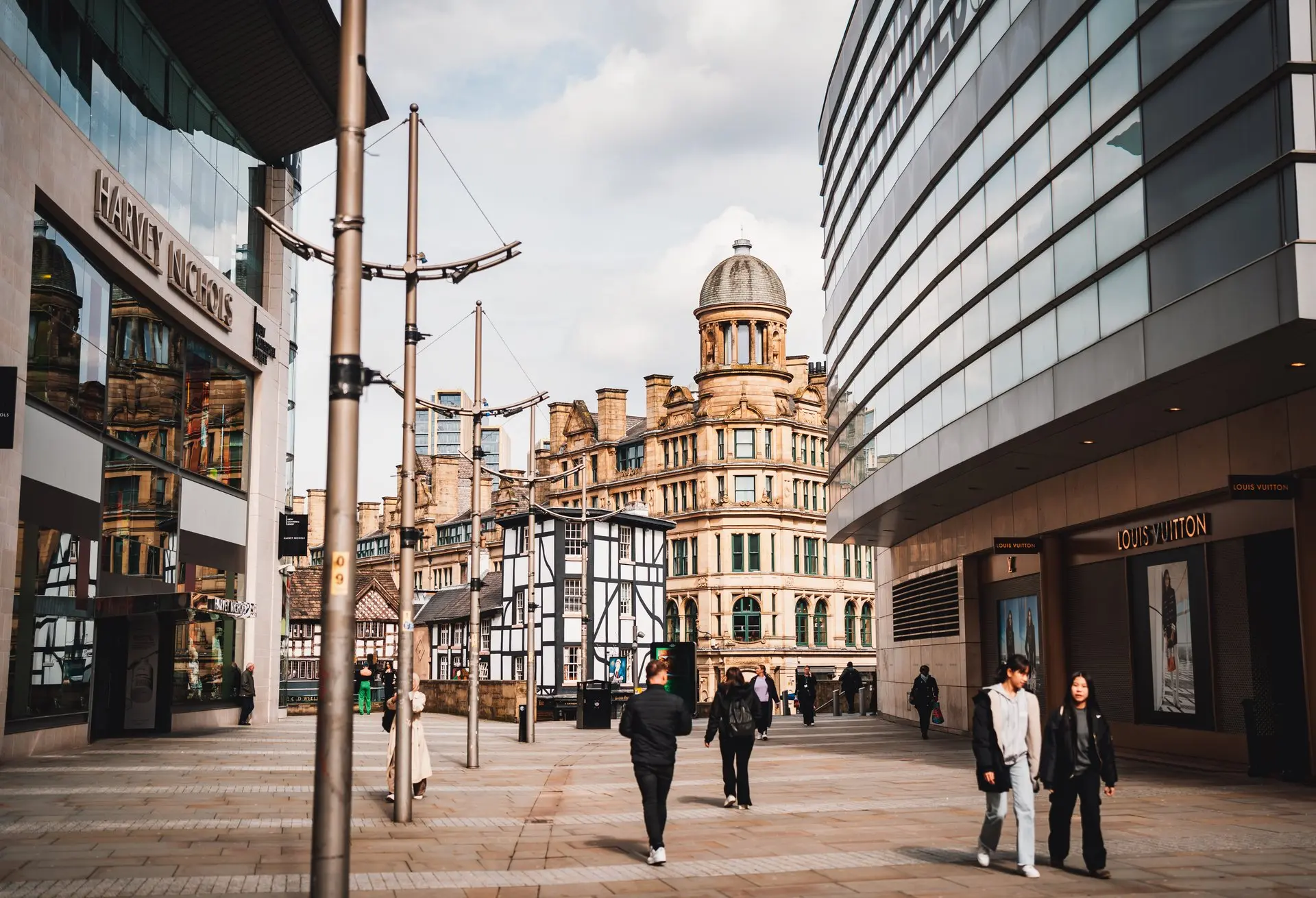 Picture of street in Manchester with people walking down it