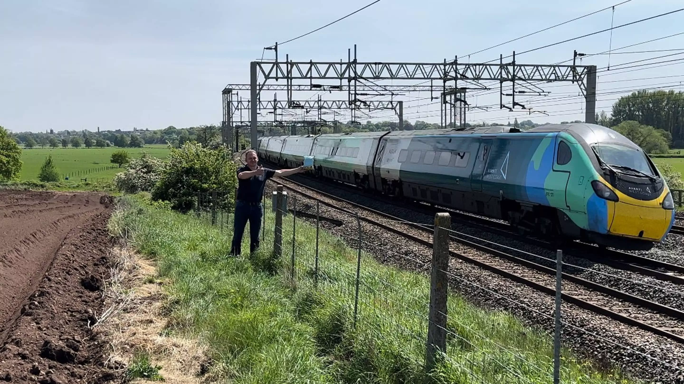 Man with crisps next to an Avanti train