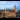 An aerial exterior shot of Leicester City Hall with birds flying from the roof.