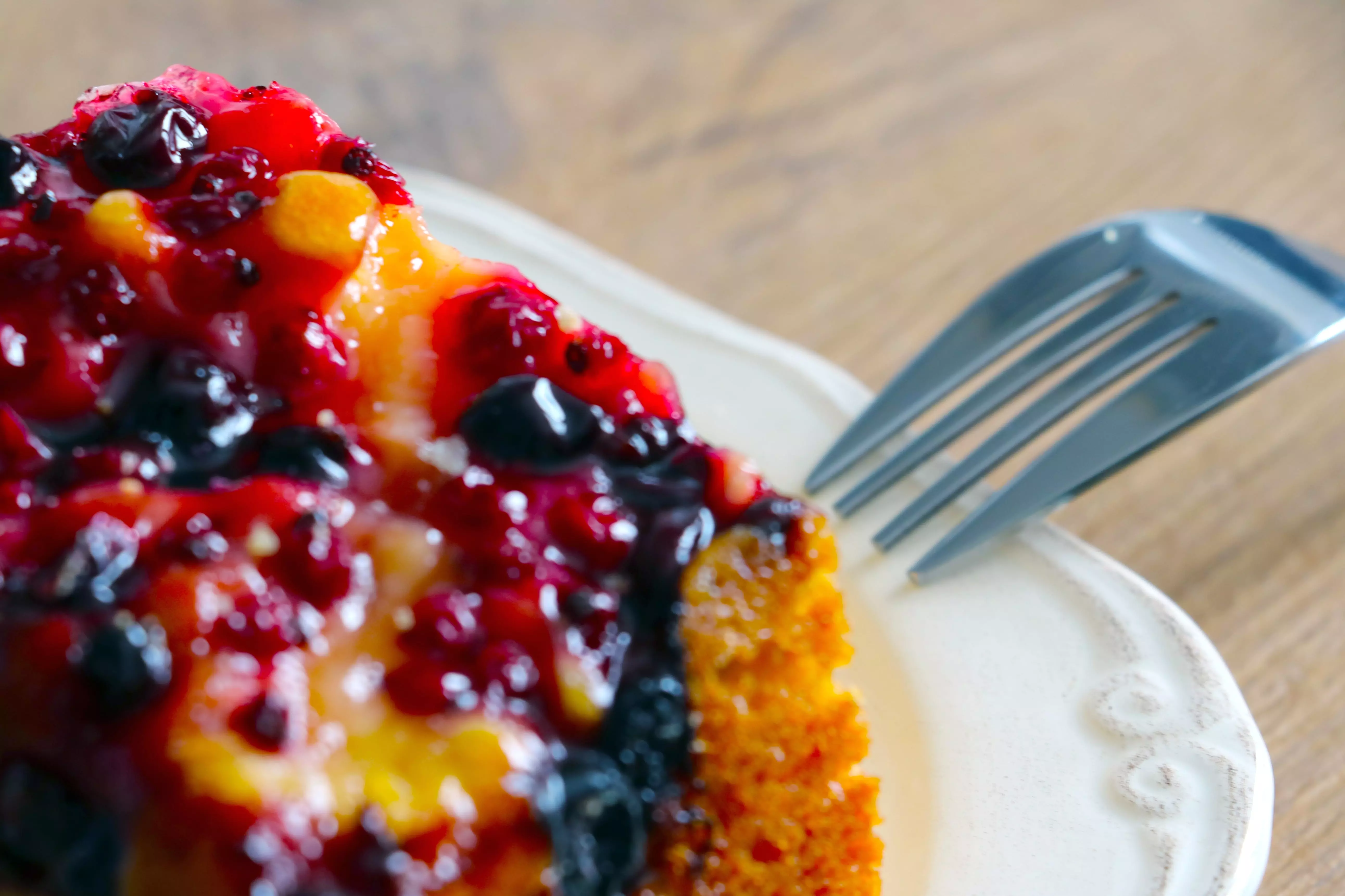 A piece of fruit topped cake on a plate.