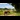 A family walking three alpacas on a countryside trail