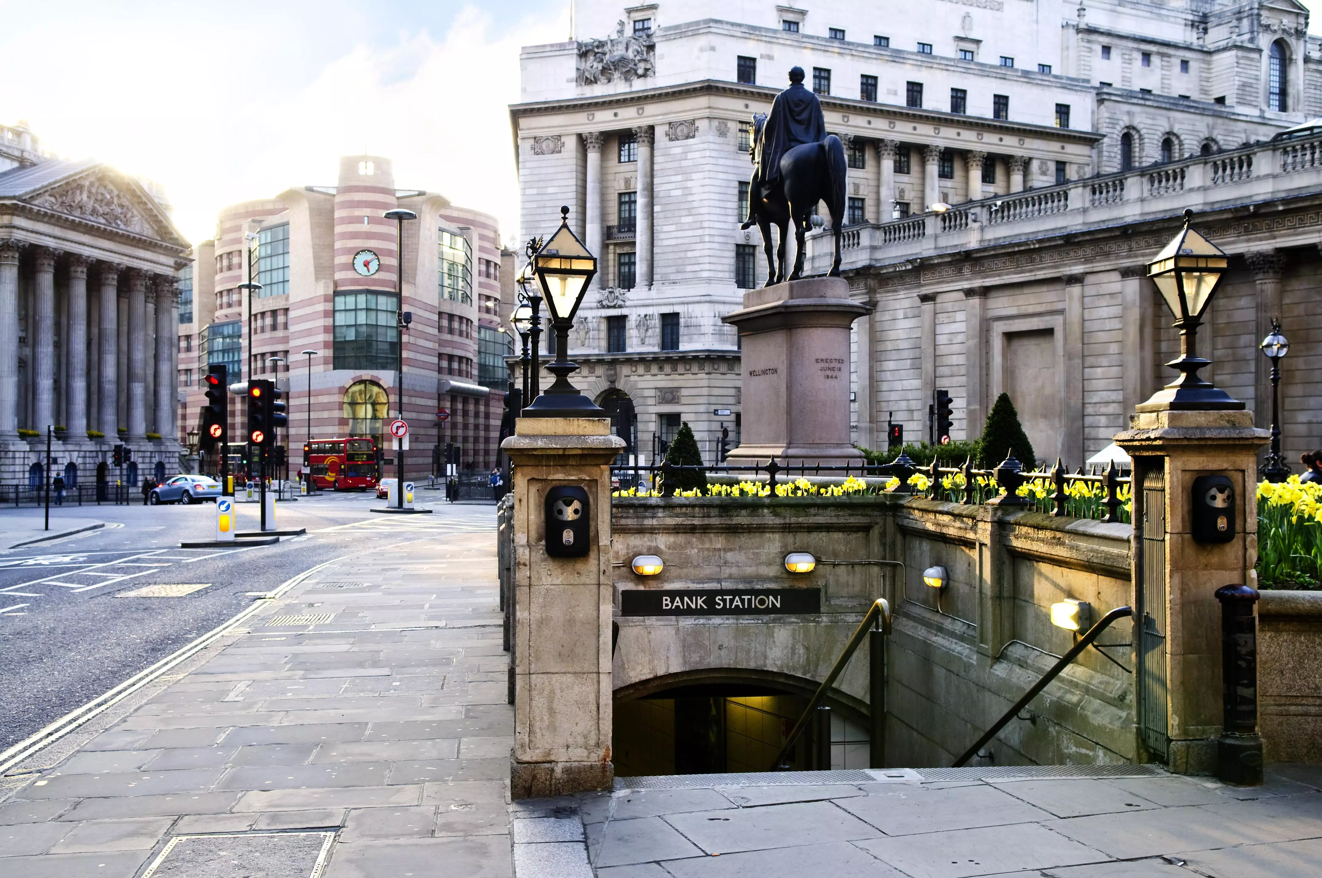 A daytime photo of the entrance to Bank Street tube station, with the Equestrian Statue of the Duke of Wellington next to it.