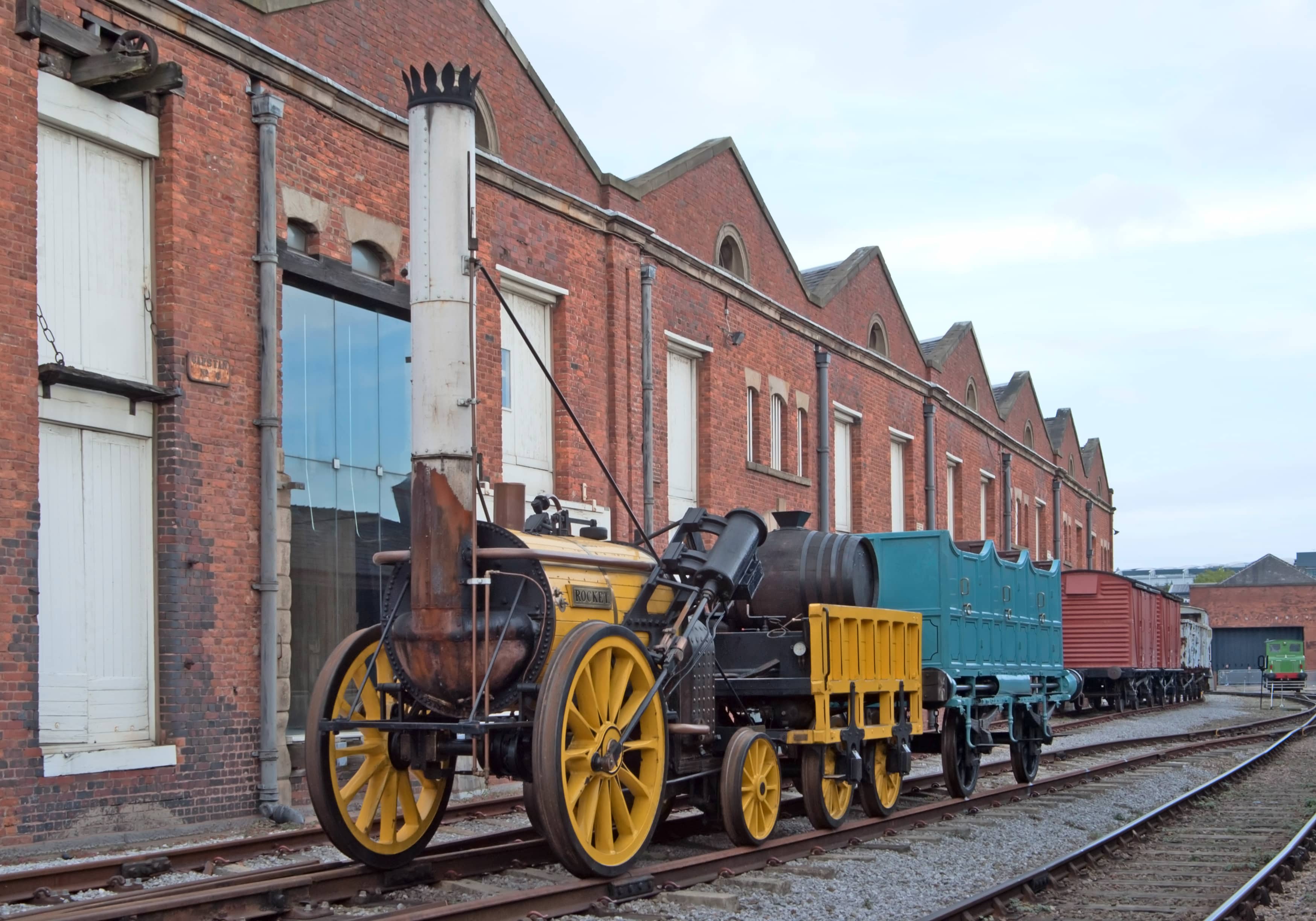 Railway Pioneers: A daytime photograph showing Stephenson’s Rocket, sporting yellow and teal colours.