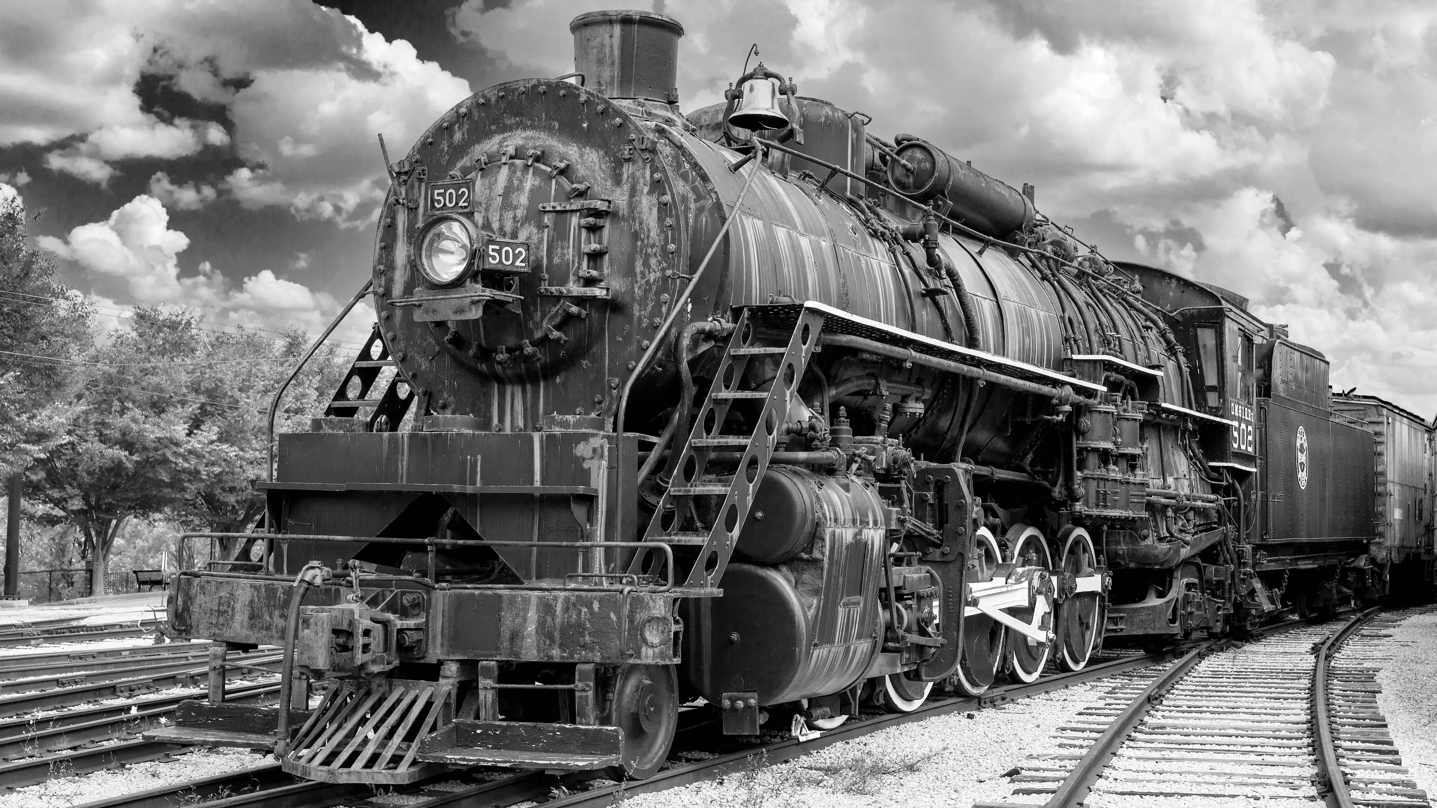Steam Train: A black and white photo of a steam engine locomotive