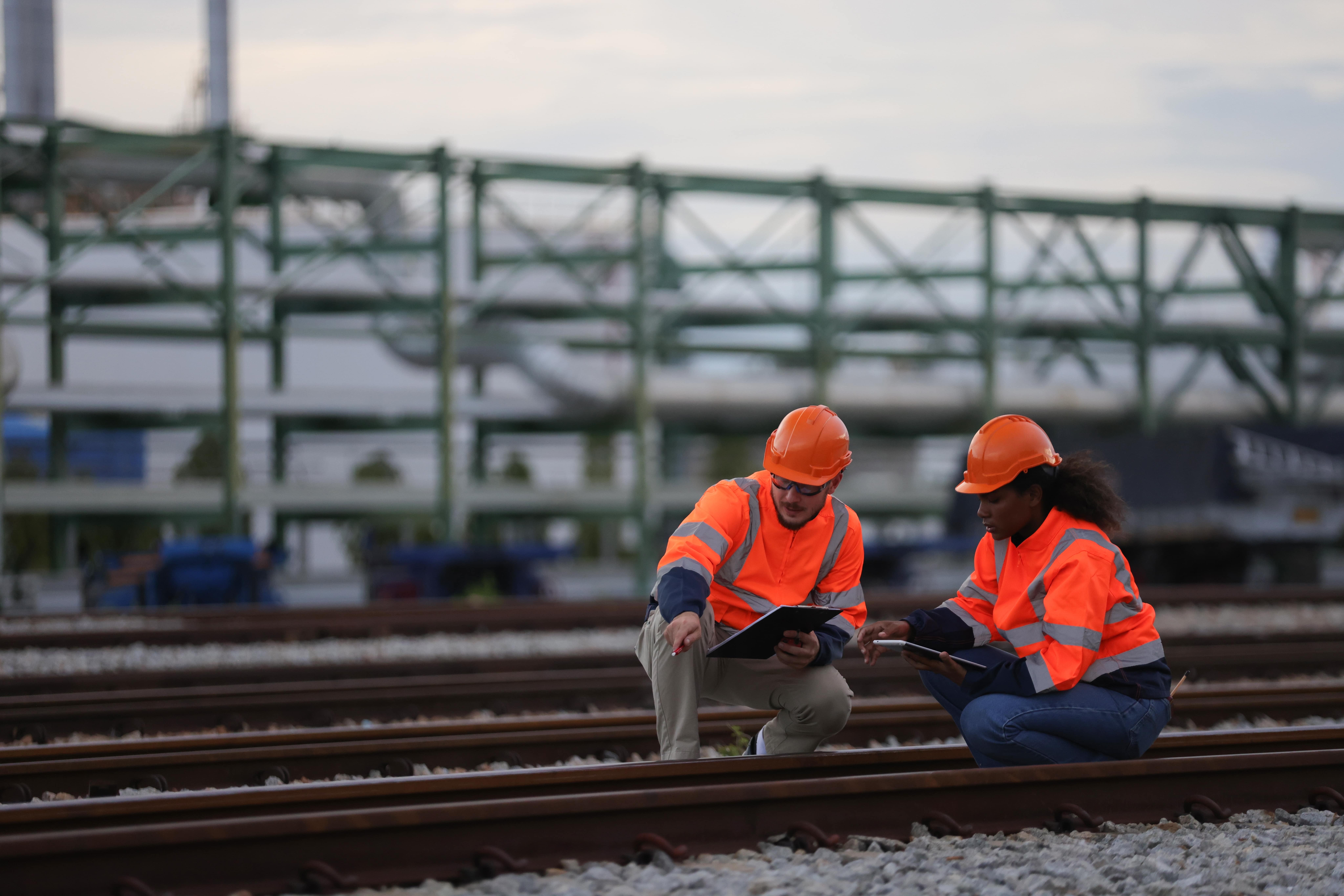 Rail Safety: Two railway engineers checking railway tracks.