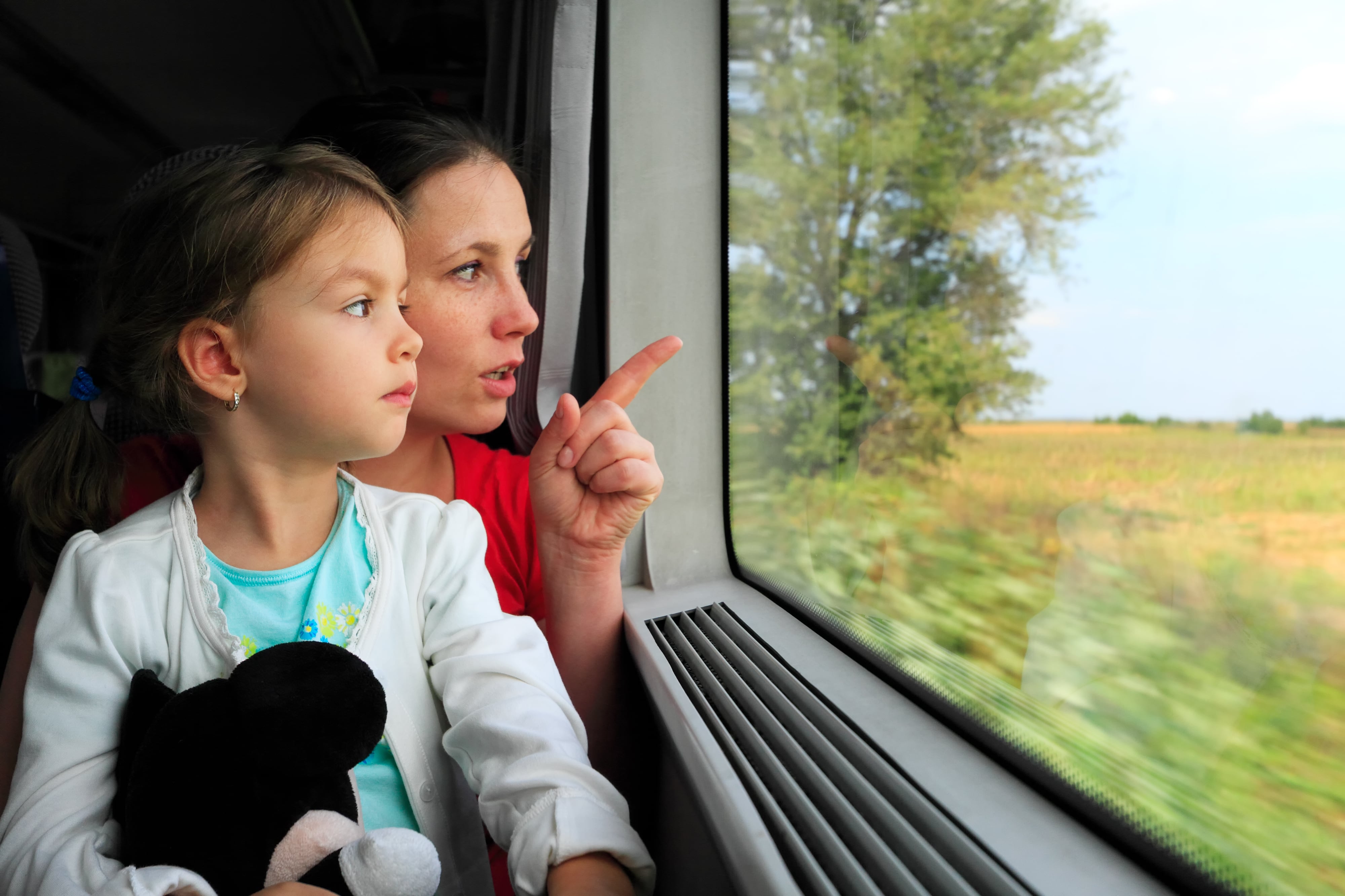 Bicentennial: A mother and daughter on a train journey, gazing out the window as the mother points at the passing countryside