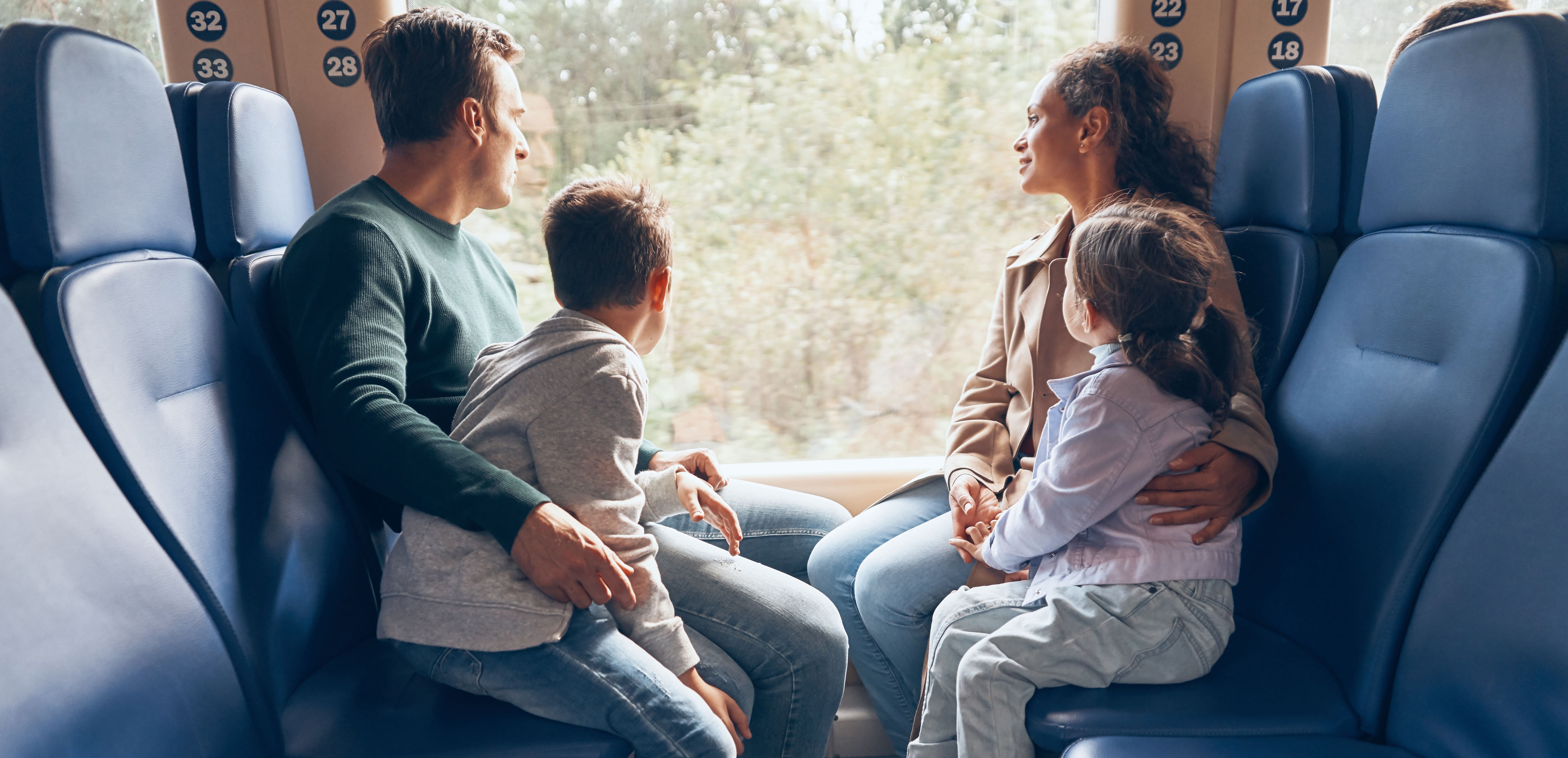 Bicentennial: A family of four enjoying a train ride, gazing out the window at passing scenery