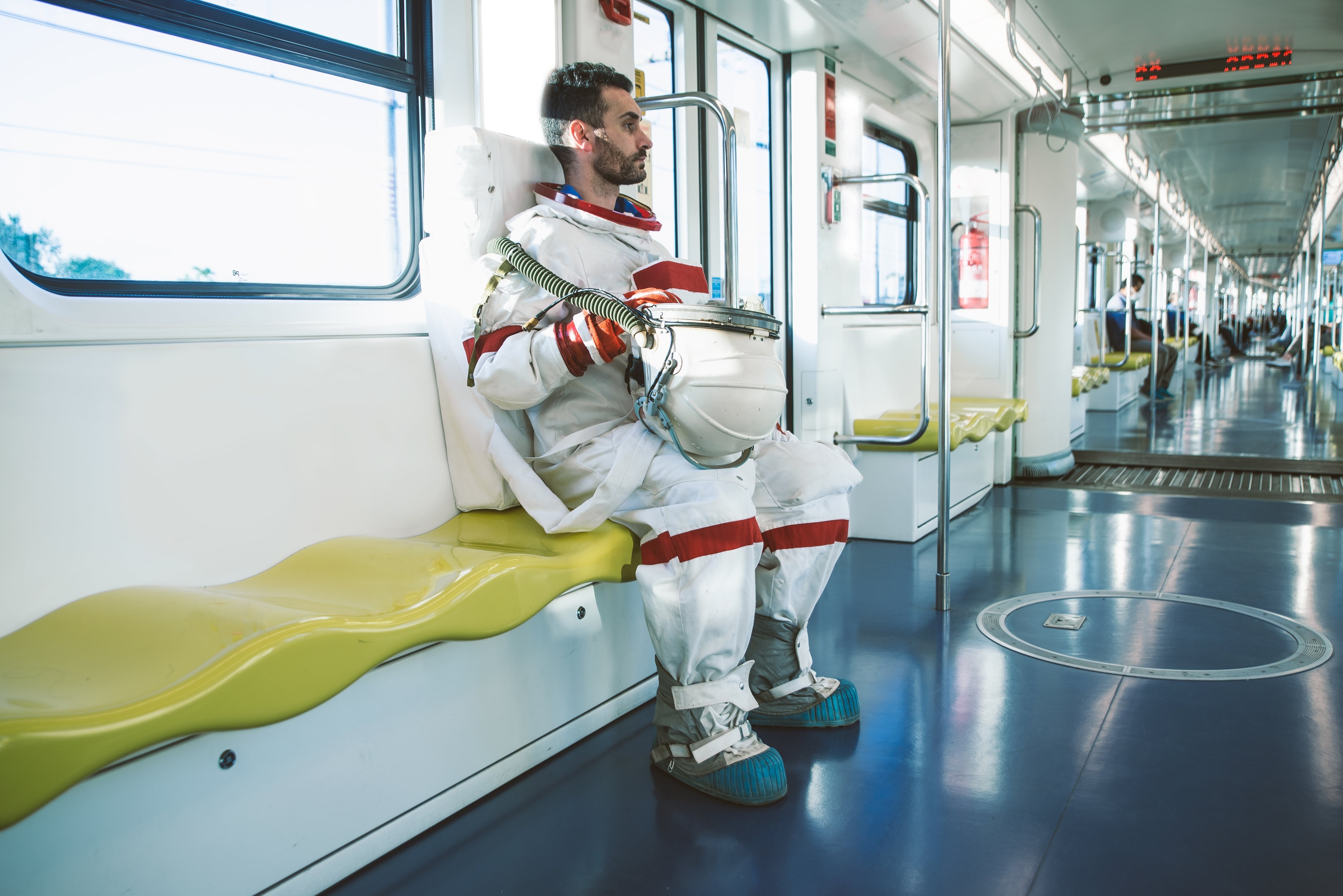 Future Trains: A helmet-less astronaut sits on a clinically clean-looking train.