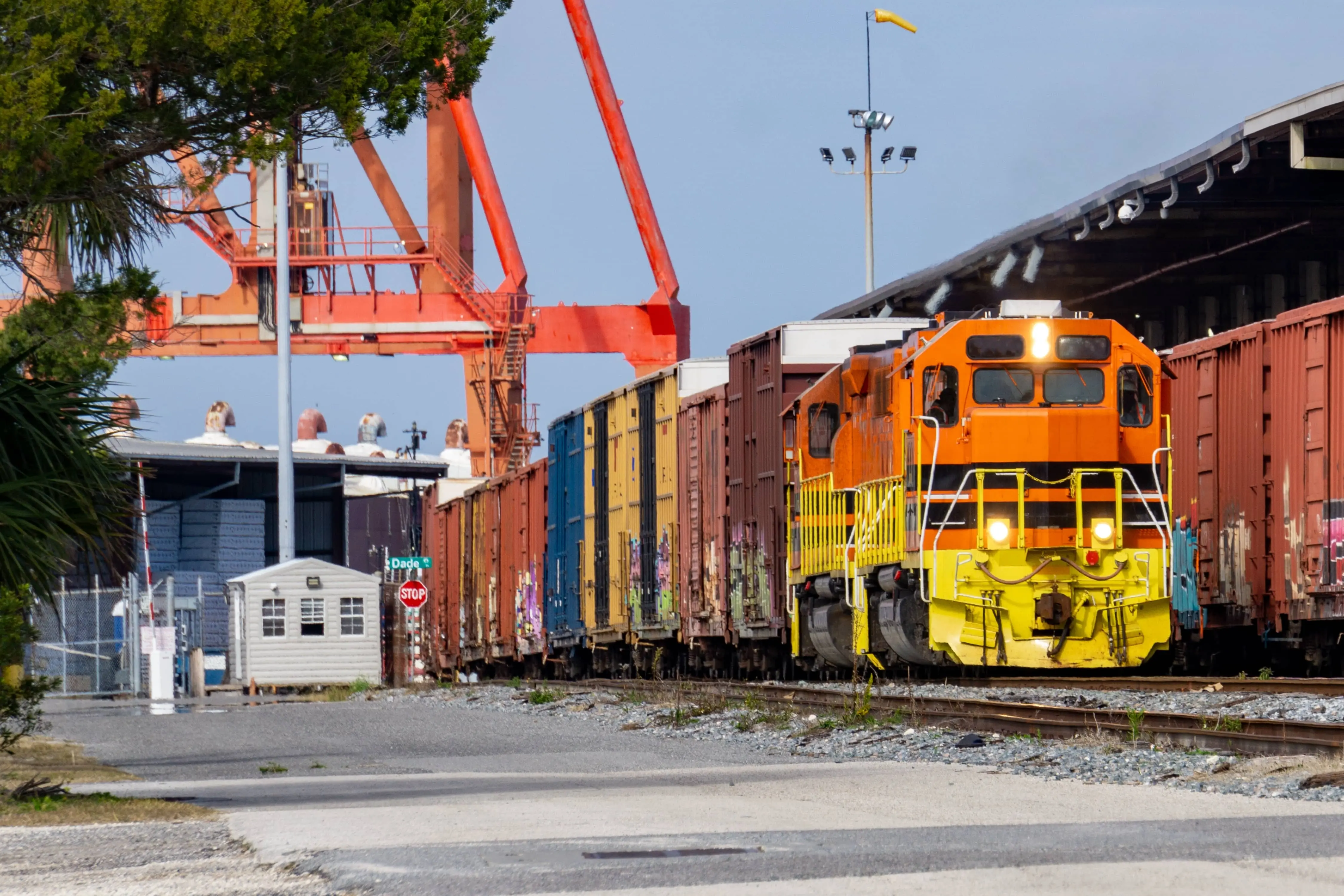 A freight train loaded with cargo pulls out of a marine terminal.