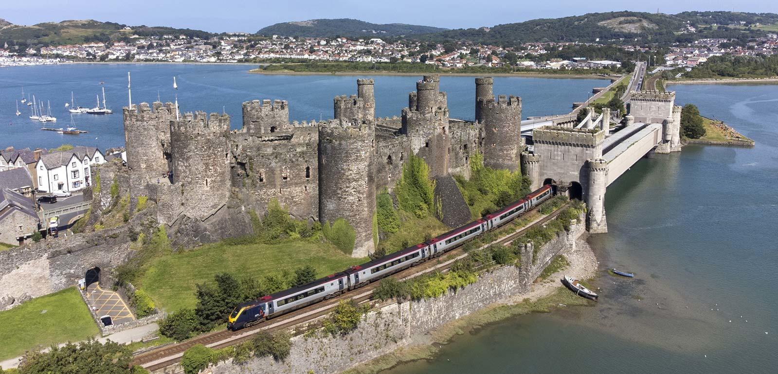 An image of an Avanti West Coast train passing Conwy Castle